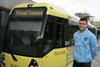 Manchester City FC player James Milner with Metrolink light rail vehicle.