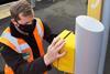 An INIT technician installing one of Merseyrail's new validators