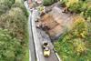 Diggers smoothing embankment