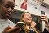 London Underground passengers using phones on the Jubilee Line (Photo TfL)