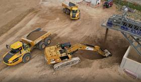 Excavators and tipper trucks at work shifting material delivered by the Wendover Conveyor