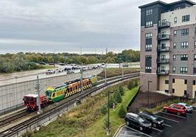 The first train is pulled along the Green Line Extension near the Southwest Station to test the tracks the entire length of the line (Metro Council)