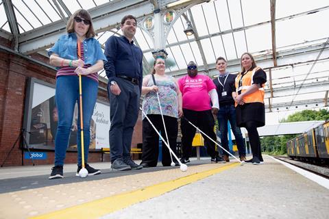 Visually impaired passengers with white sticks waiting to board a Tyne & Wear Metro train
