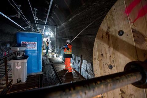Installation of catenary and contact wires through a tunnel on the approach to San Francisco.