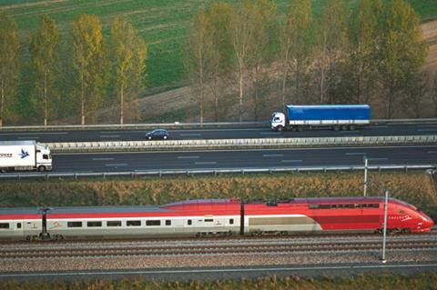 Thalys train alongside a motorway