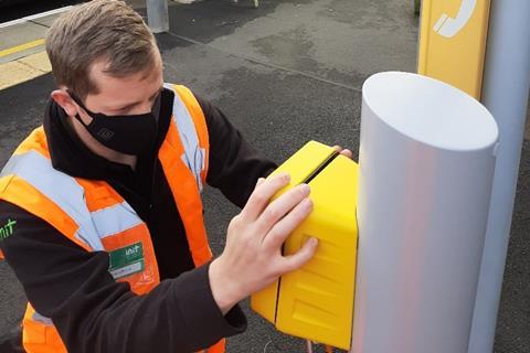 An INIT technician installing one of Merseyrail's new validators