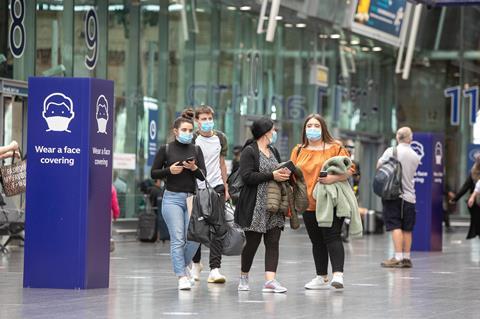 gb People wearing face coverings at Manchester Piccadilly station during the coronavirus pandemic