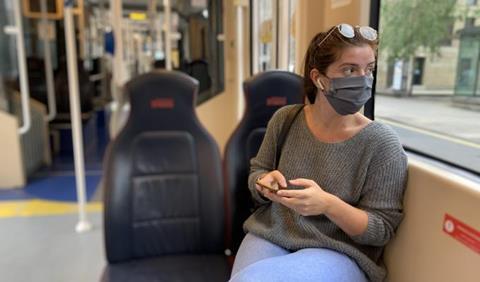 Edinburgh tram passenger wearing a face covering