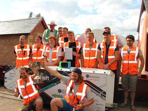 The winning FH Aachen team celebrates with IMechE head judge Bill Reeve of Transport Scotland.