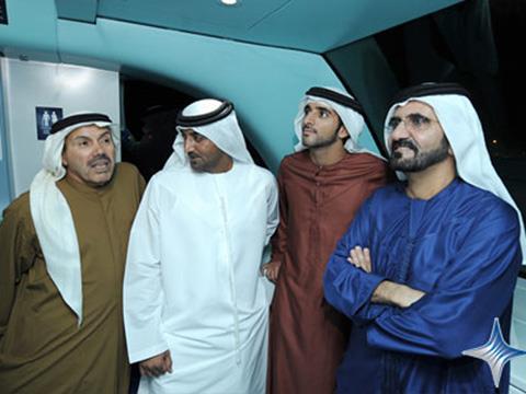 Sheikh Mohammed (in blue) enjoys the inaugural ride on the Red Line.