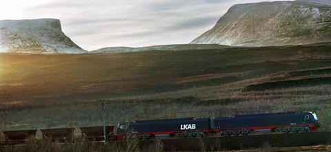 LKAB Malmtrafik AB freight train with locomotives on track, and Lapporten in background, Kiruna. Copyright Alstom SA