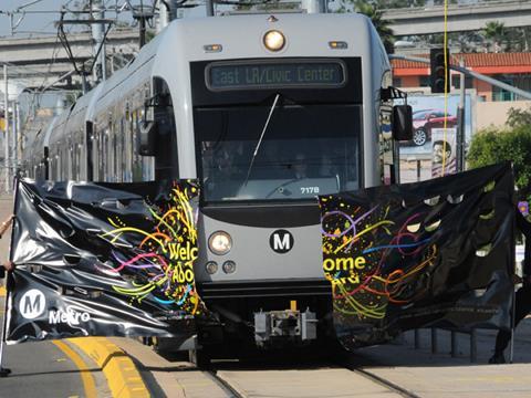 Metro Gold Line train breaks through banner at offical ceremony.