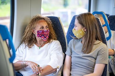Two passengers wearing coronavirus face coverings on a Thameslink train (Photo: Go- Ahead)