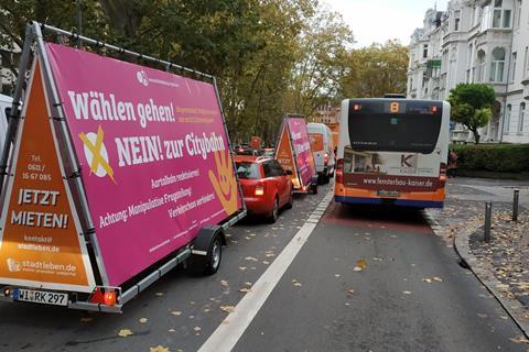 Opponents of the Wiesbaden light rail project in a queue of traffic alongside a bus lane
