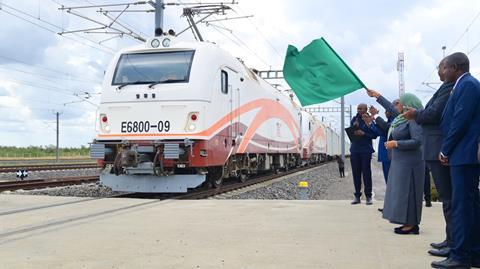 President of the United Republic of Tanzania, Hon. Dr. Samia Suluhu Hassan waving a flag to mark the official launch of freight transport using the SGR electric train transport from Dar es Salaam to Dodoma