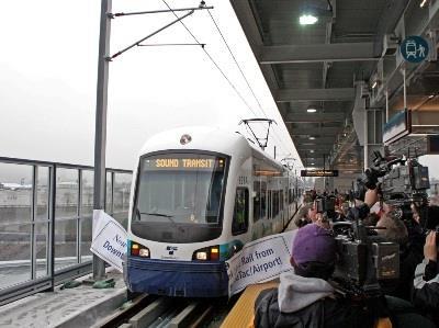 The first train breaks through the ribbon at Sound Transit’s  SeaTac/Airport Station on December 19.