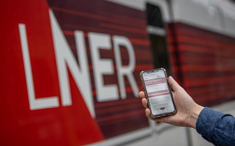 LNER passenger holding mobile phone