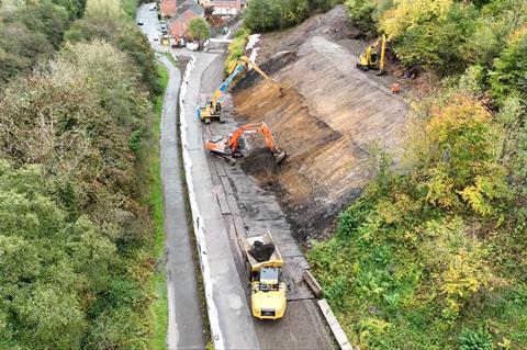 Diggers smoothing embankment