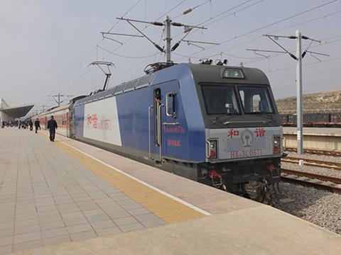 A train from Kunming stands at Mengzi Bei station.