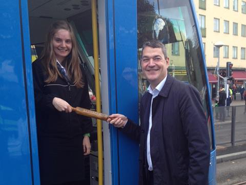 Arriva Sverige Managing Director Johan Åhlander hands driver Rebecca Schaffhauser a token granting authority to depart on the Tvärbanan extension.