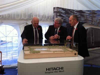 Business Secretary Vince Cable (left) and Transport Secretary Patrick McLoughlin (centre) examine a model of Hitachi's Newton Aycliffe plant during the start of work ceremony.