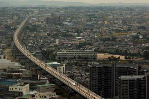 jp-Long Shinkansen bridge over an existing railway line in Kurume city with Series 800
